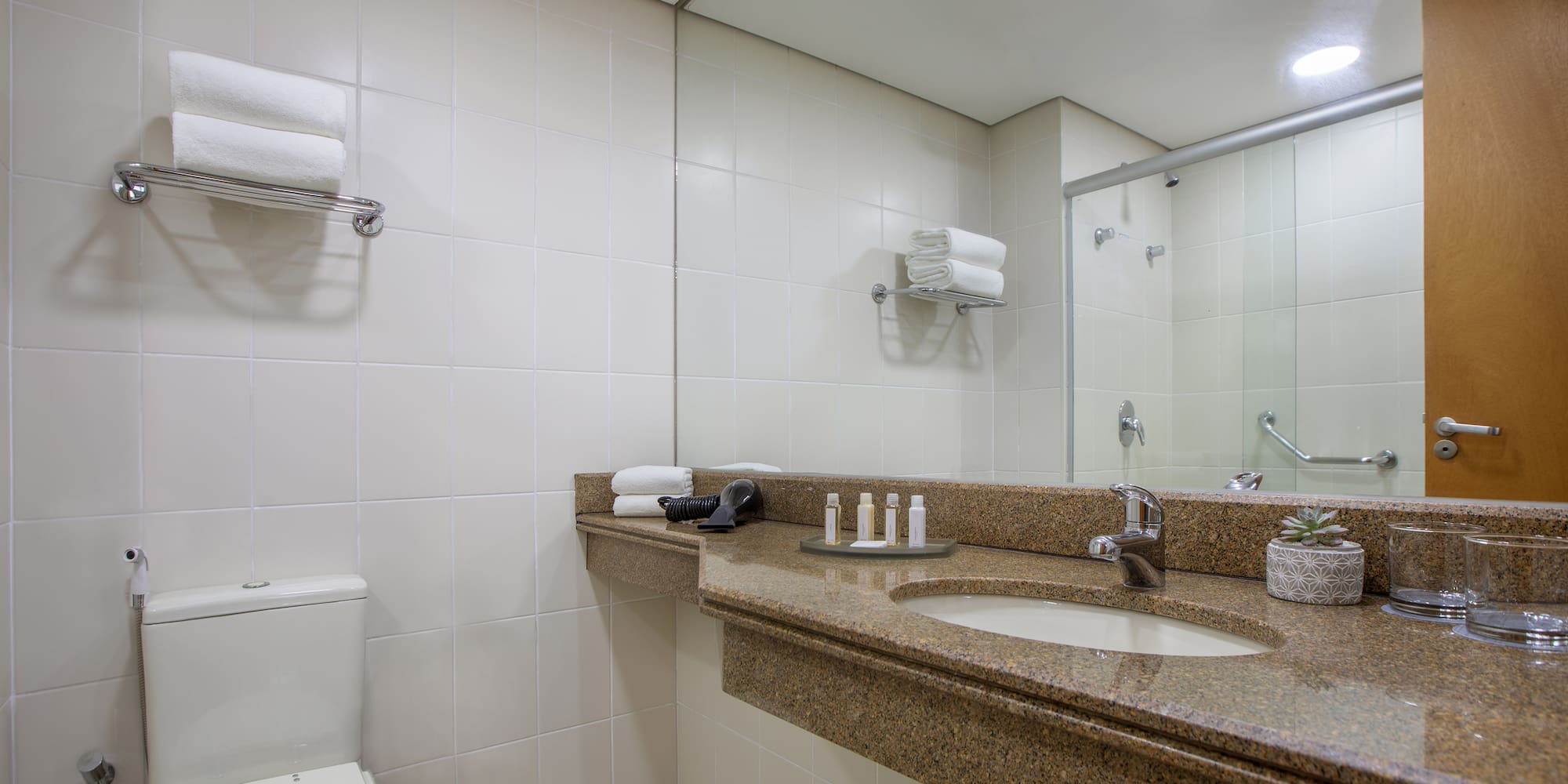 a bathroom with a marble countertop and a toilet