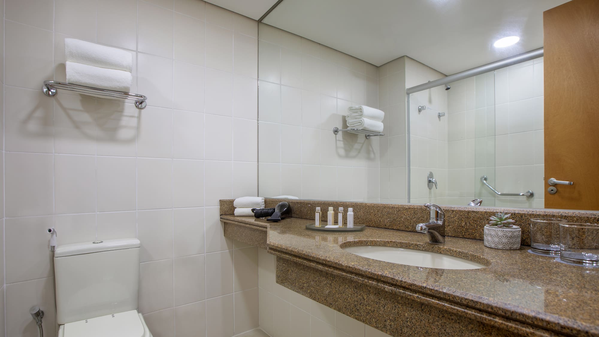 a bathroom with a marble countertop and a toilet