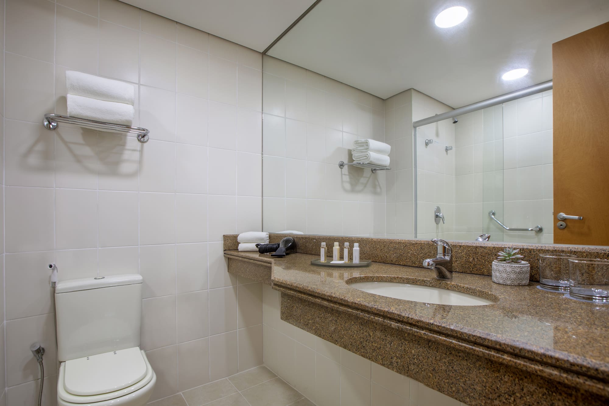 a bathroom with a marble countertop and a toilet