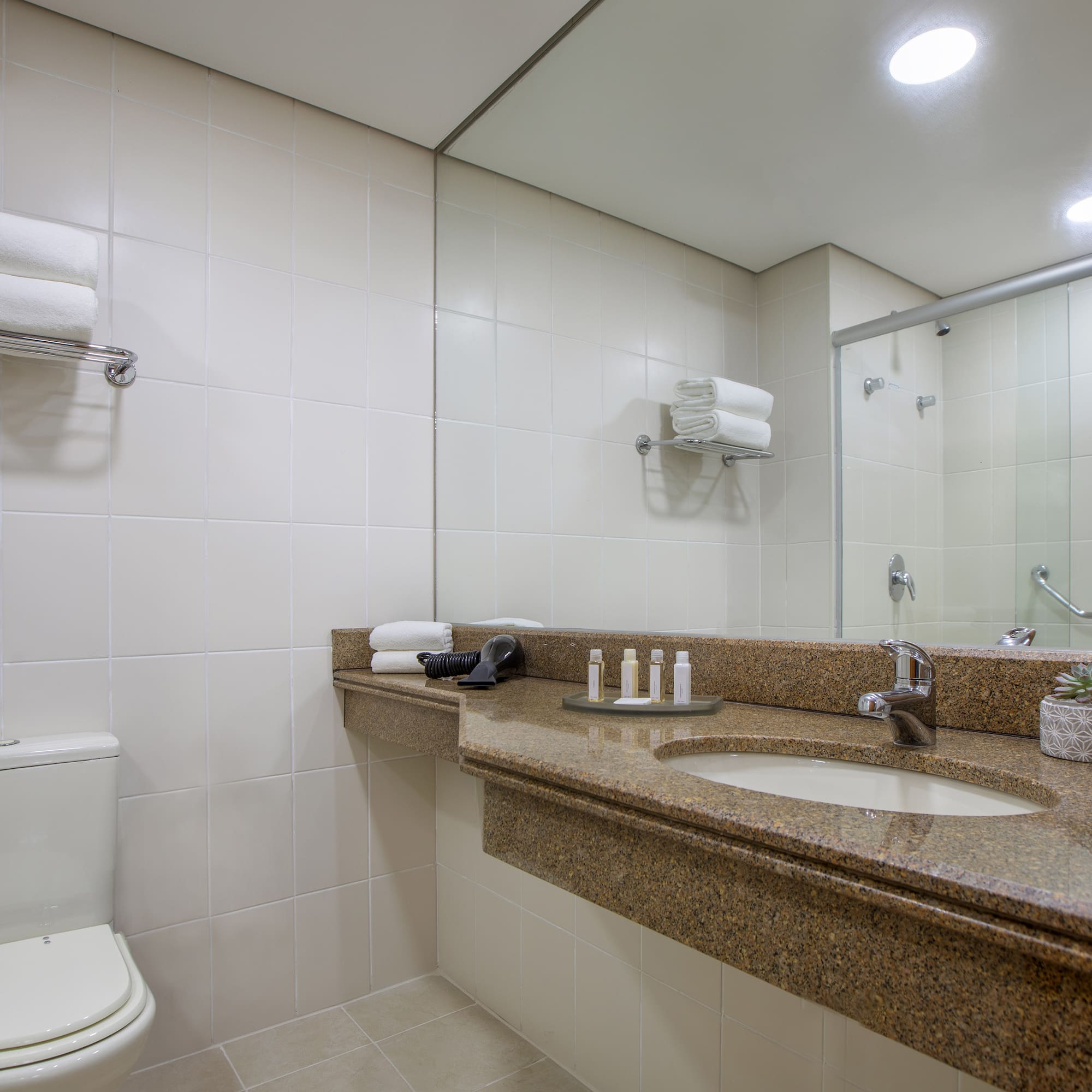 a bathroom with a marble countertop and a toilet