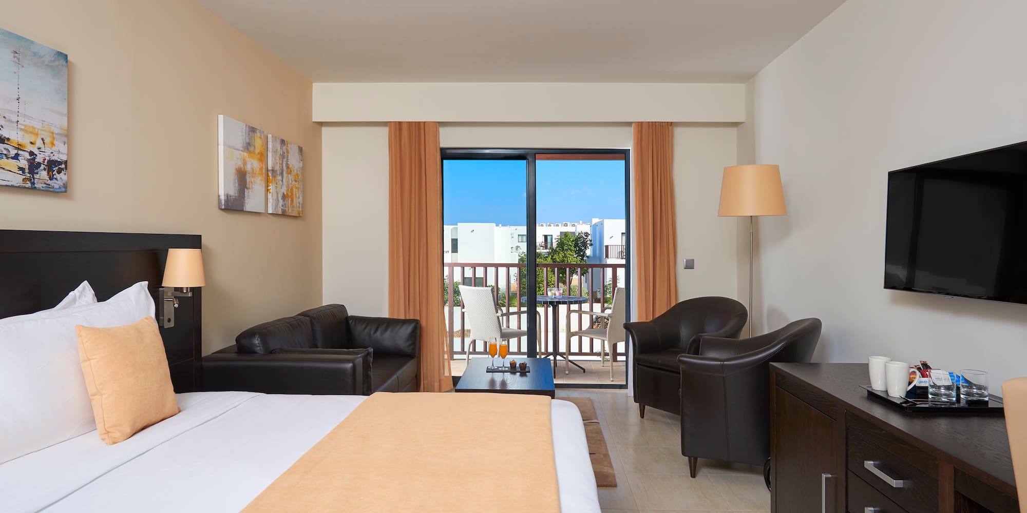 a room with a bed and chairs and a table