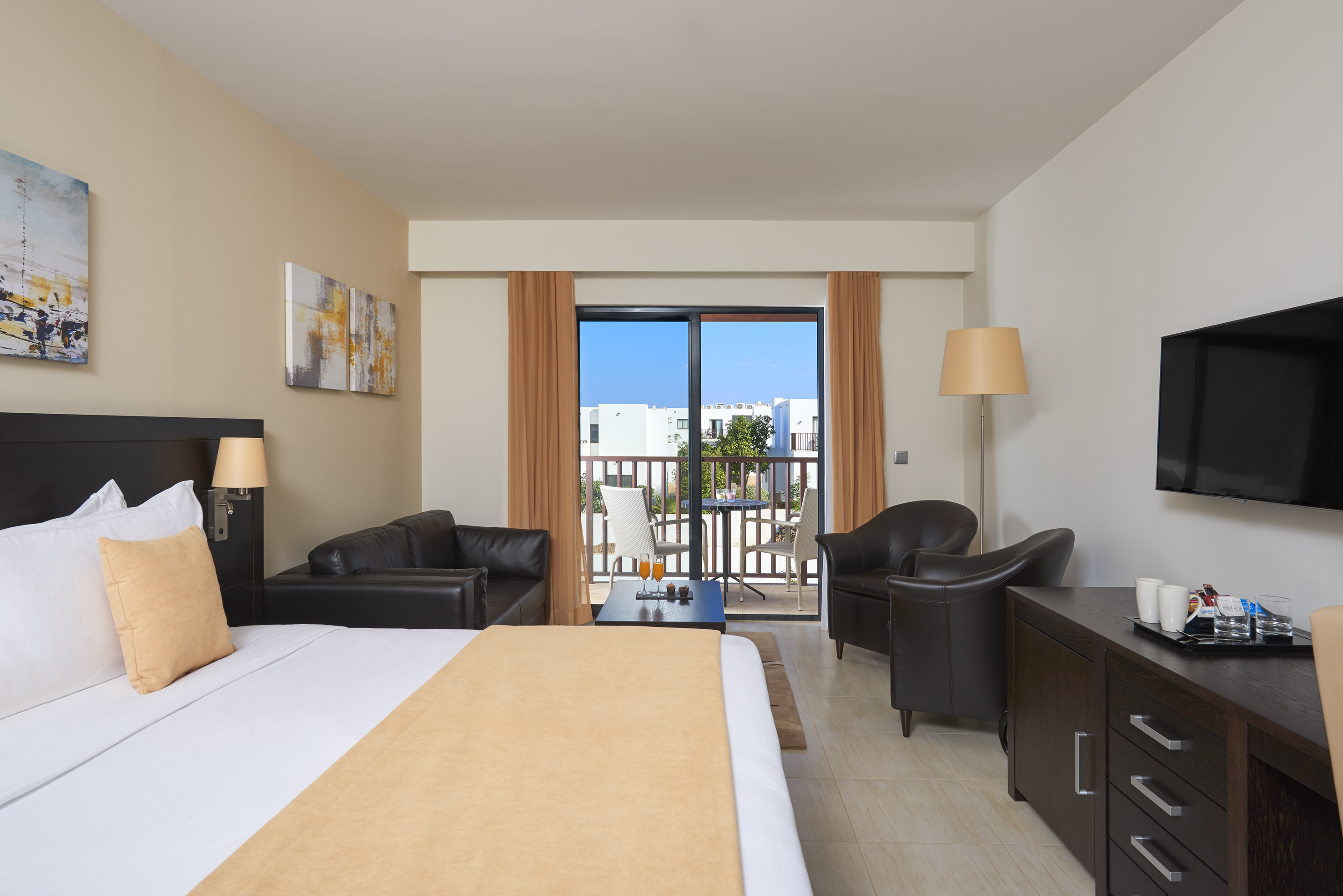 a room with a bed and chairs and a table