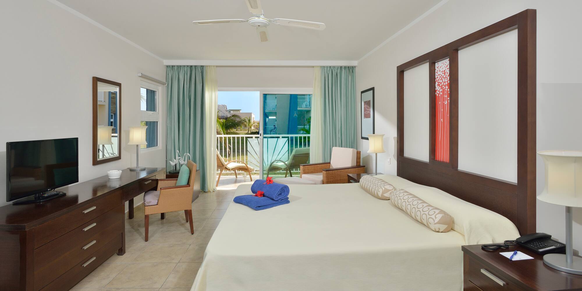 a room with a bed and a desk and chairs