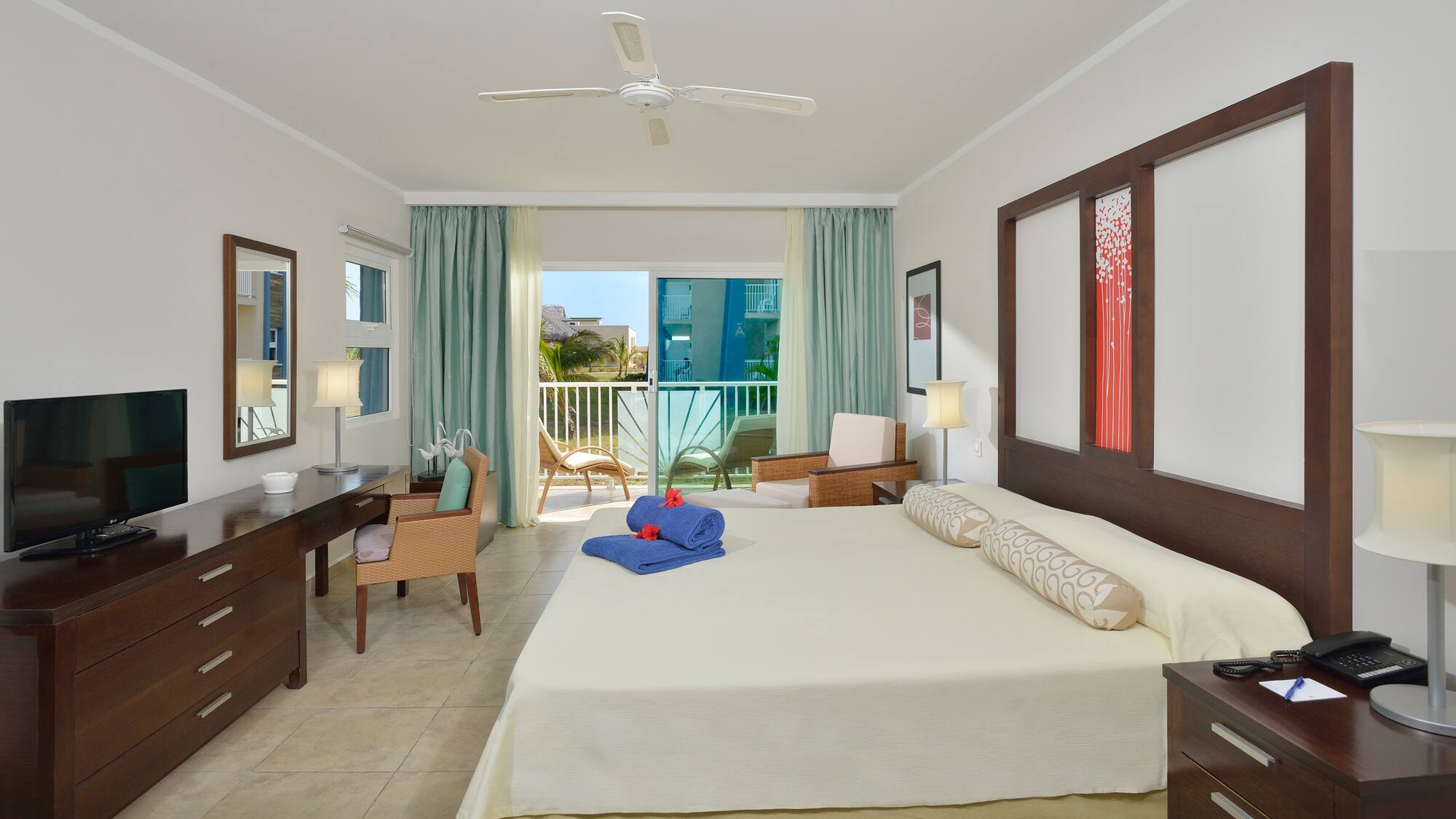 a room with a bed and a desk and chairs