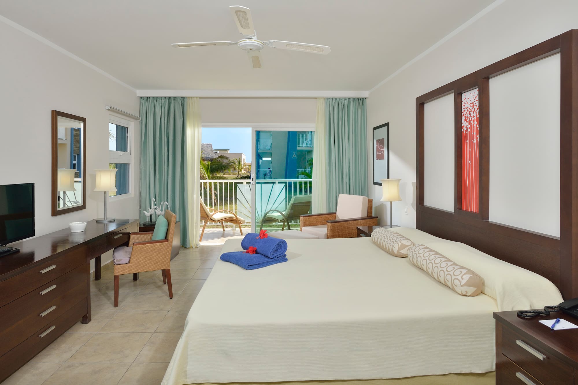 a room with a bed and a desk and chairs