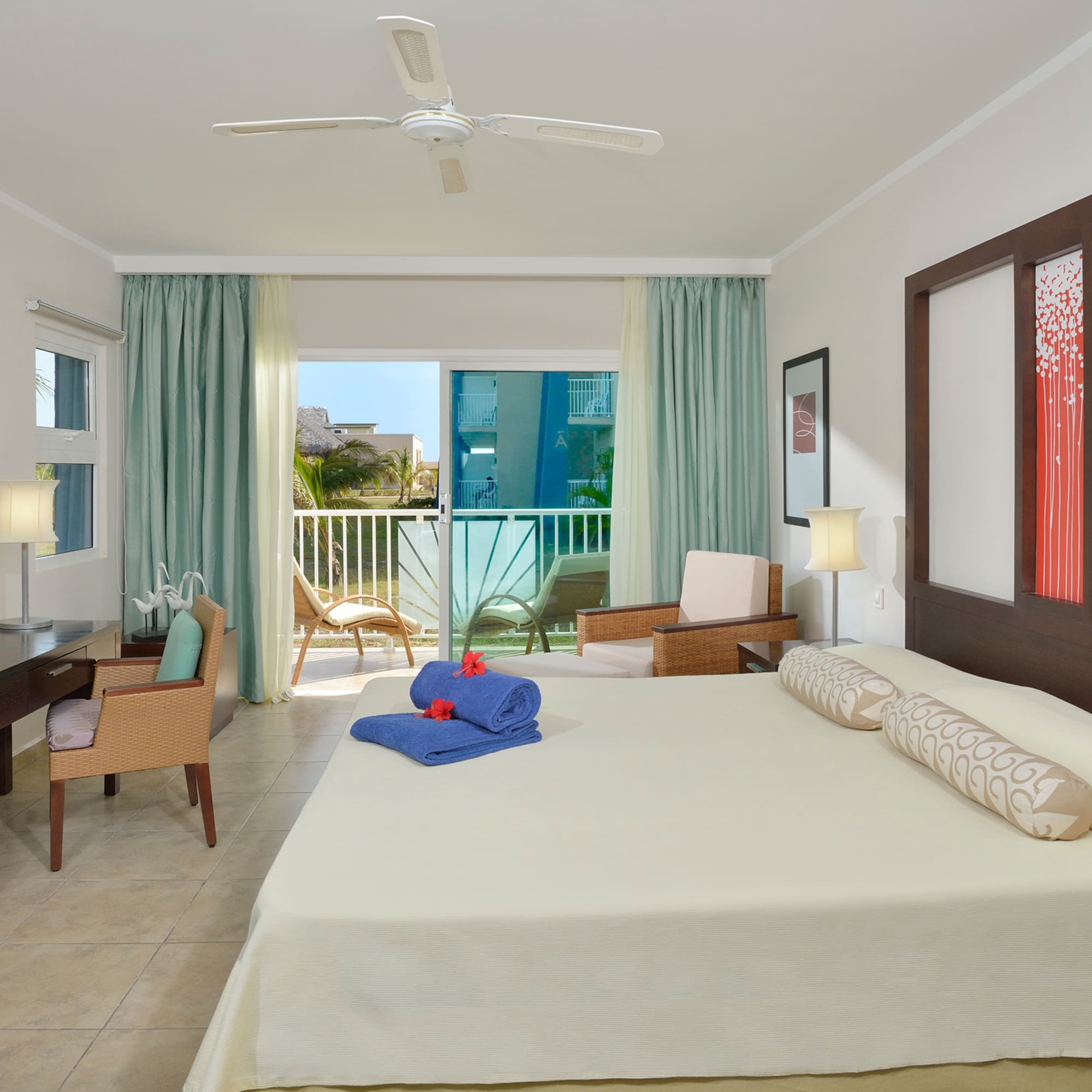 a room with a bed and a desk and chairs