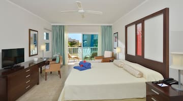 a room with a bed and a desk and chairs