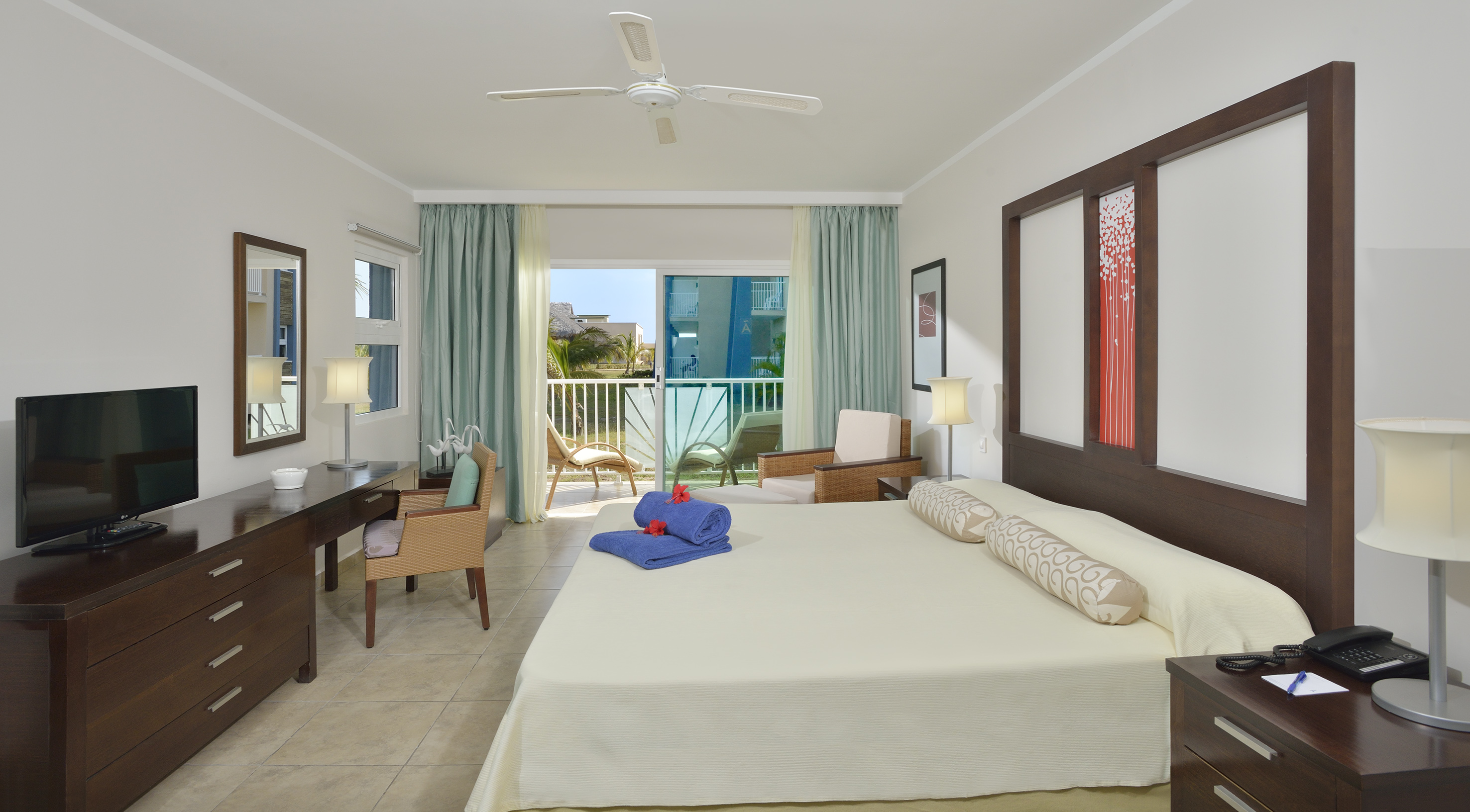 a room with a bed and a desk and chairs