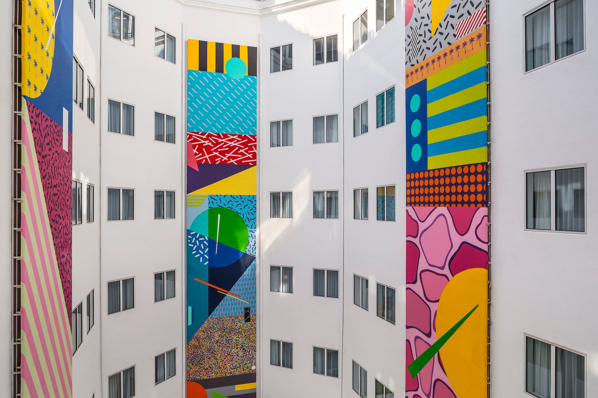 a multistory building with colorful artwork on the walls