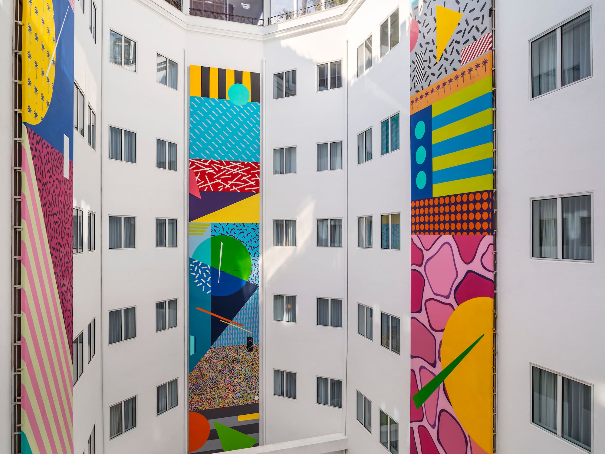 a multistory building with colorful artwork on the walls