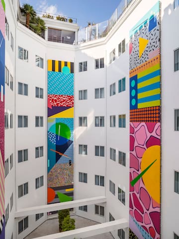 a multistory building with colorful artwork on the walls
