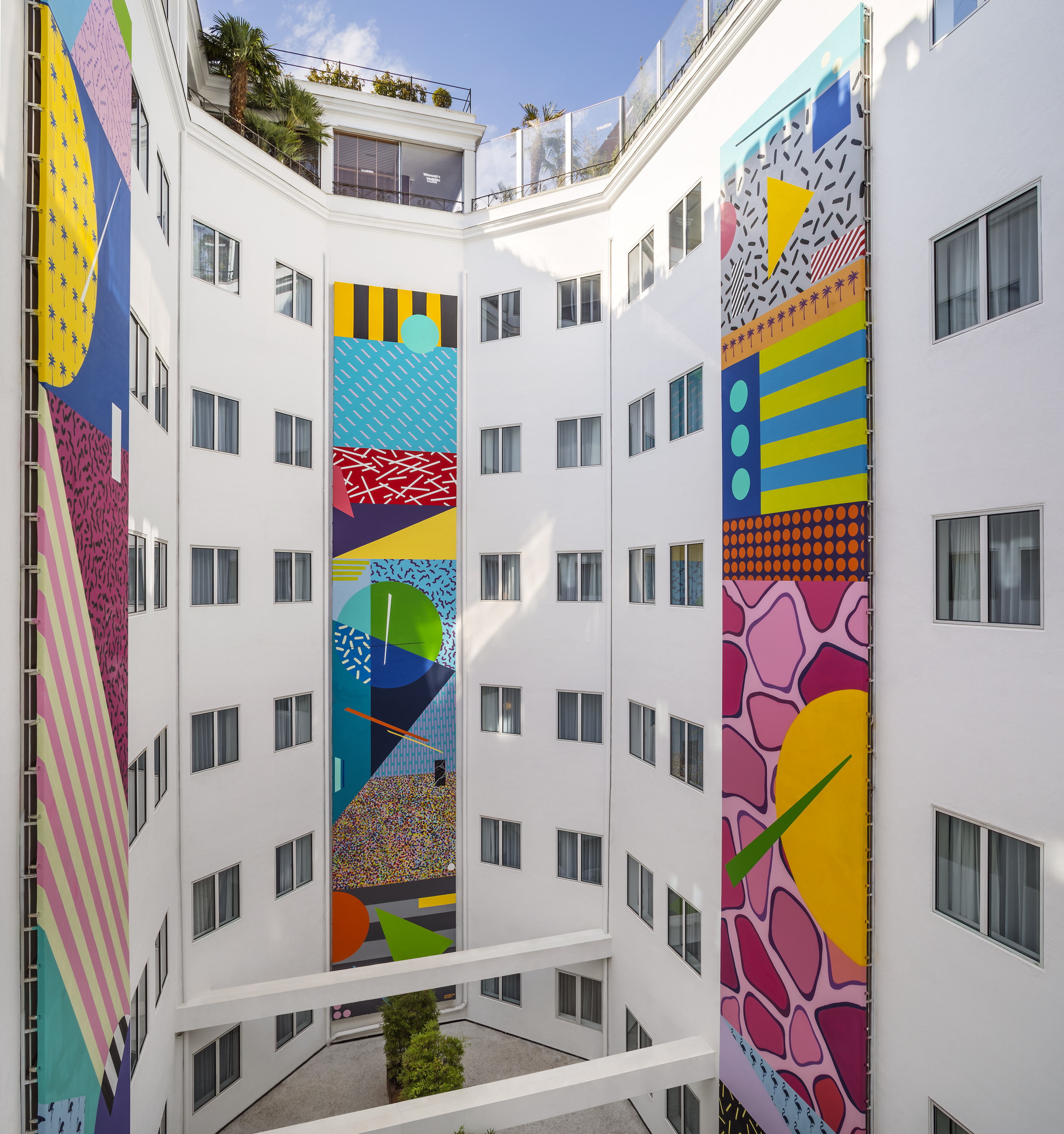 a multistory building with colorful artwork on the walls