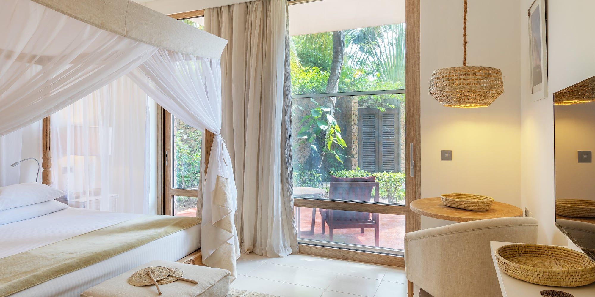 a room with a bed and chairs