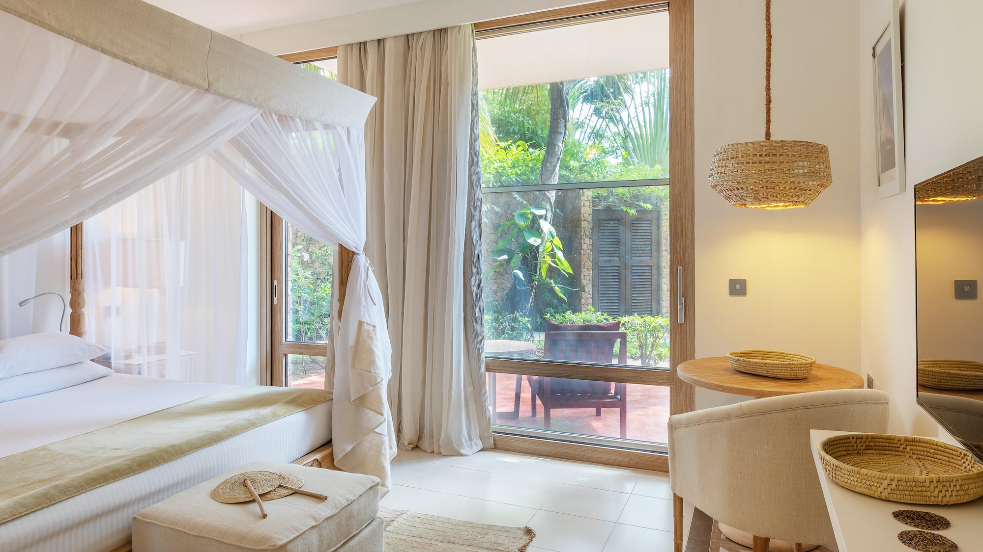 a room with a bed and chairs