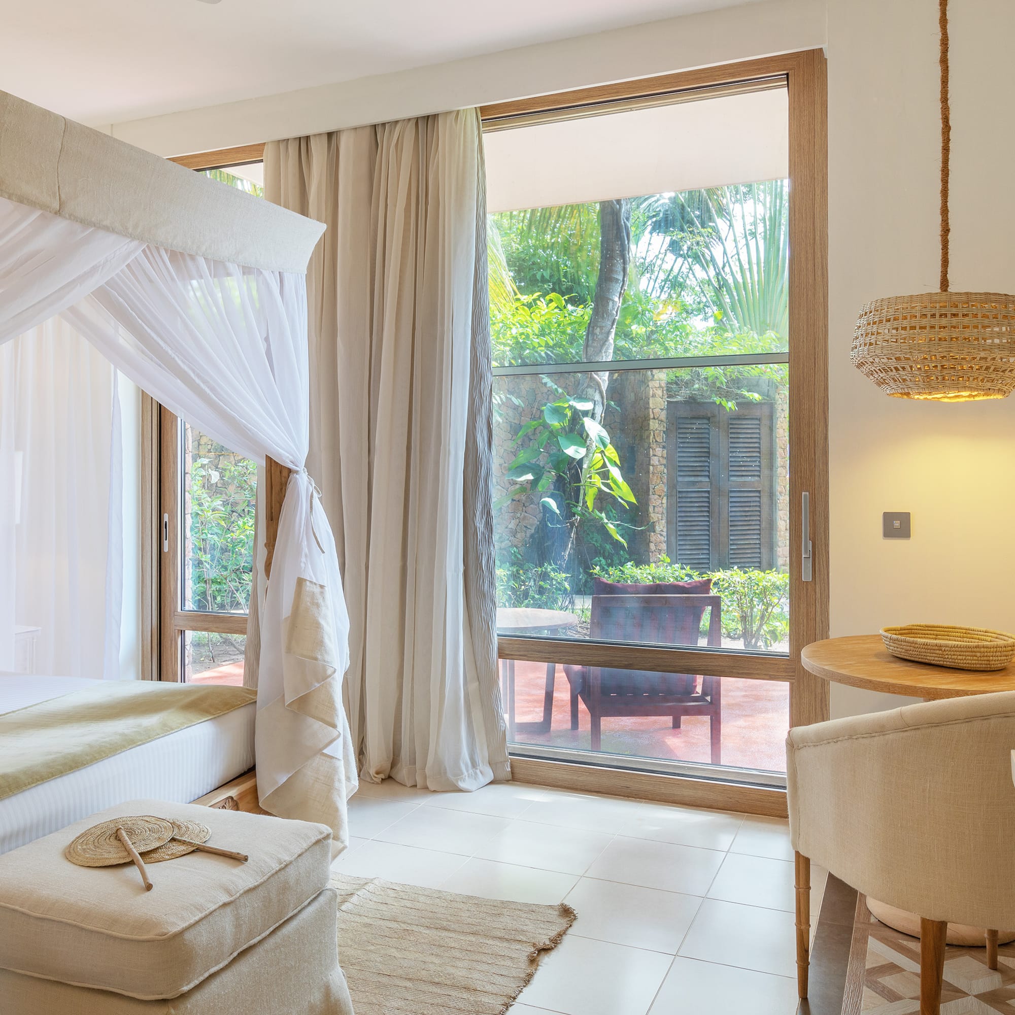 a room with a bed and chairs