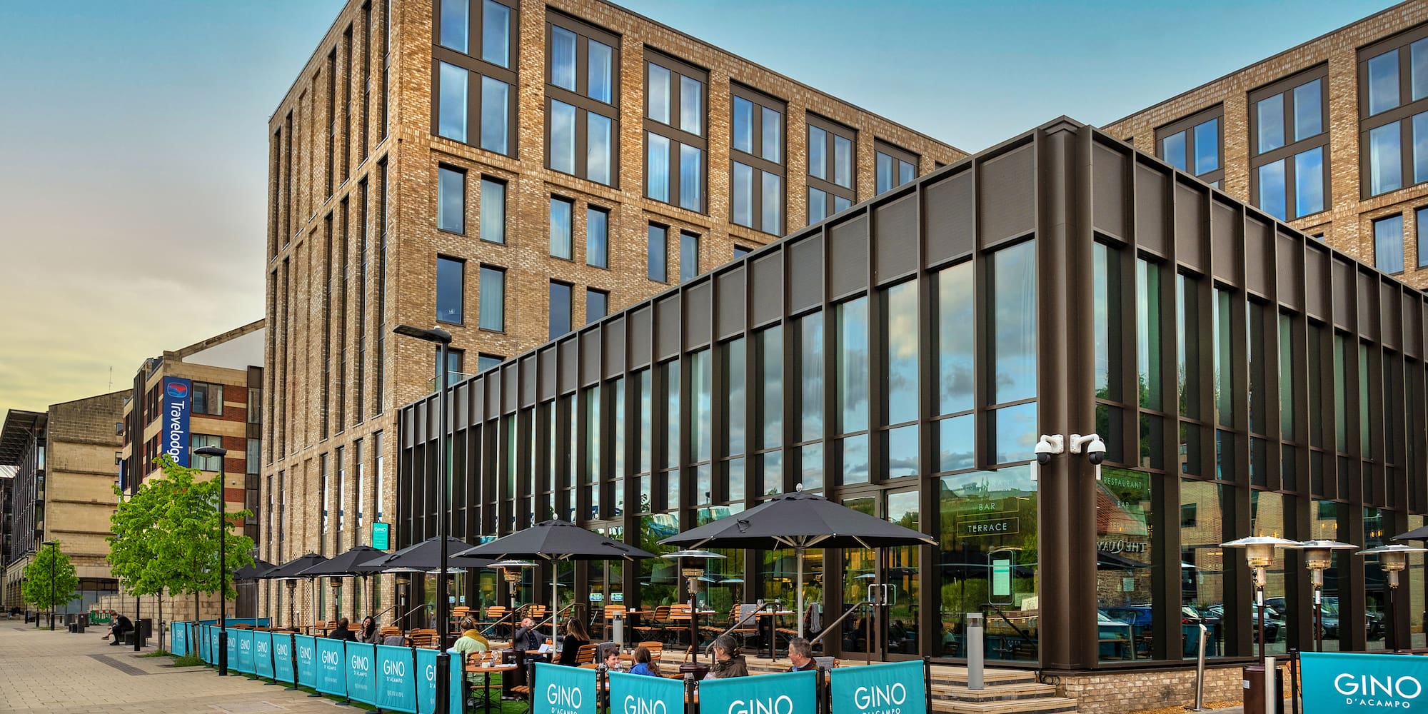 a building with a glass wall and a large building with windows