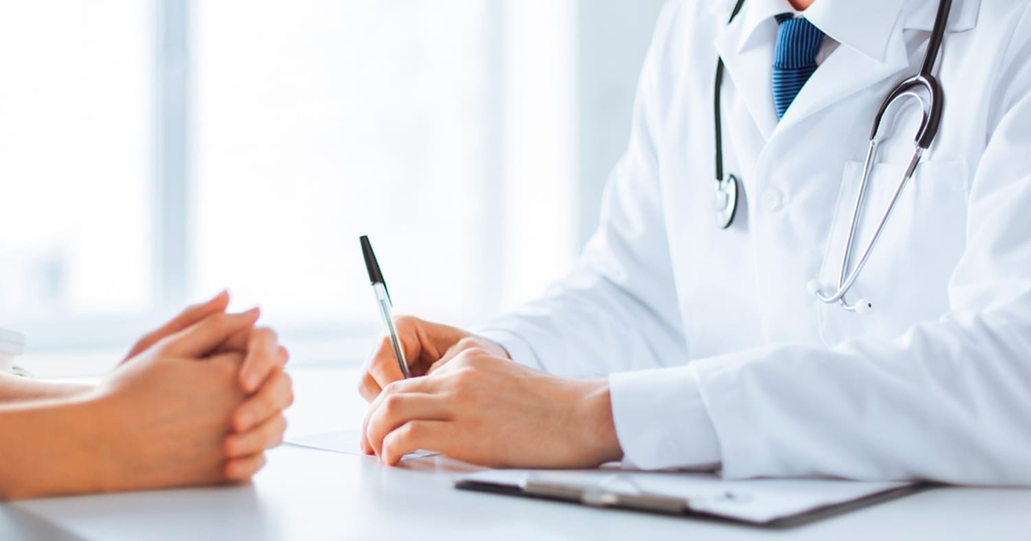 a doctor writing on a paper