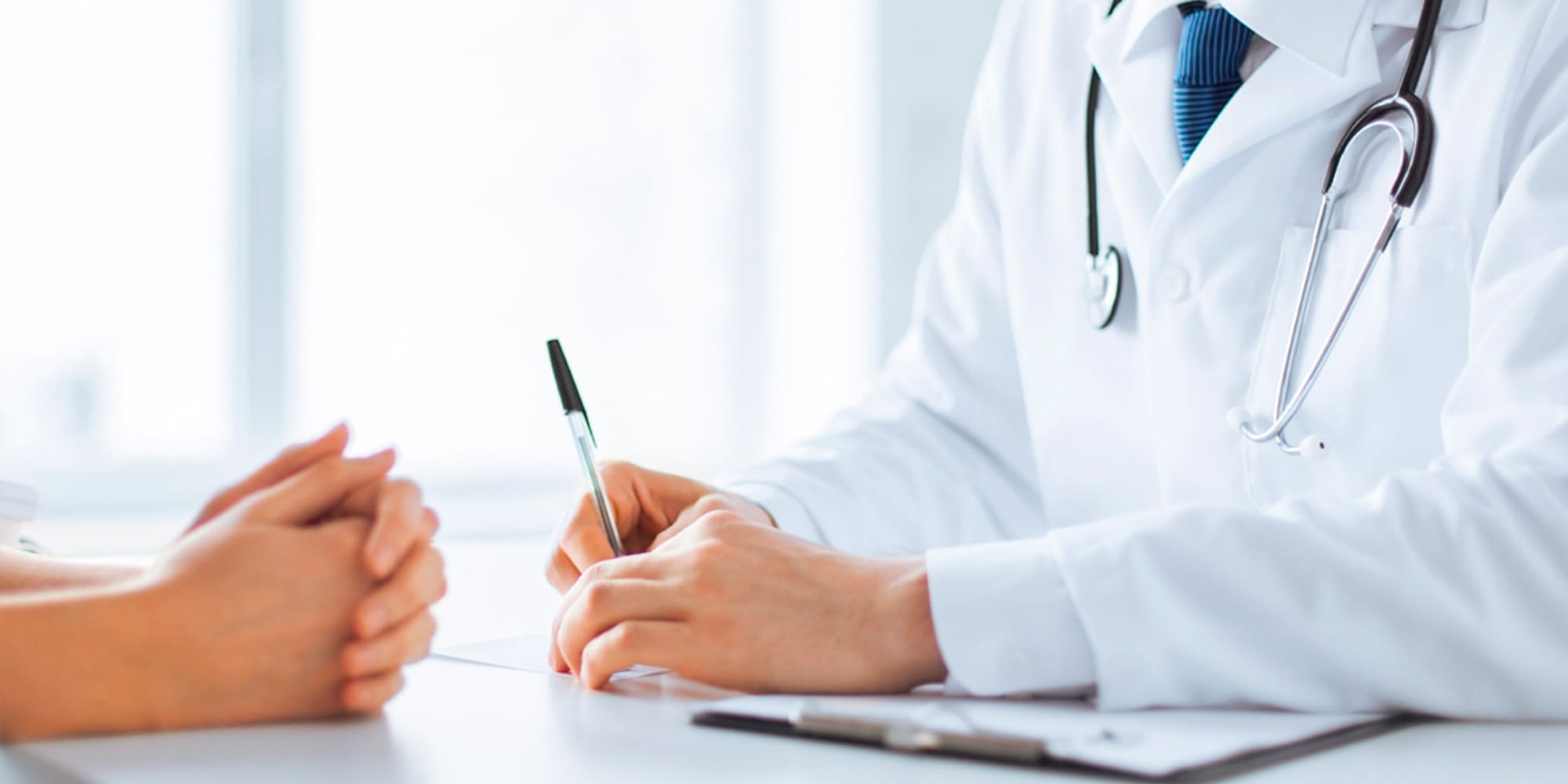 a doctor writing on a paper