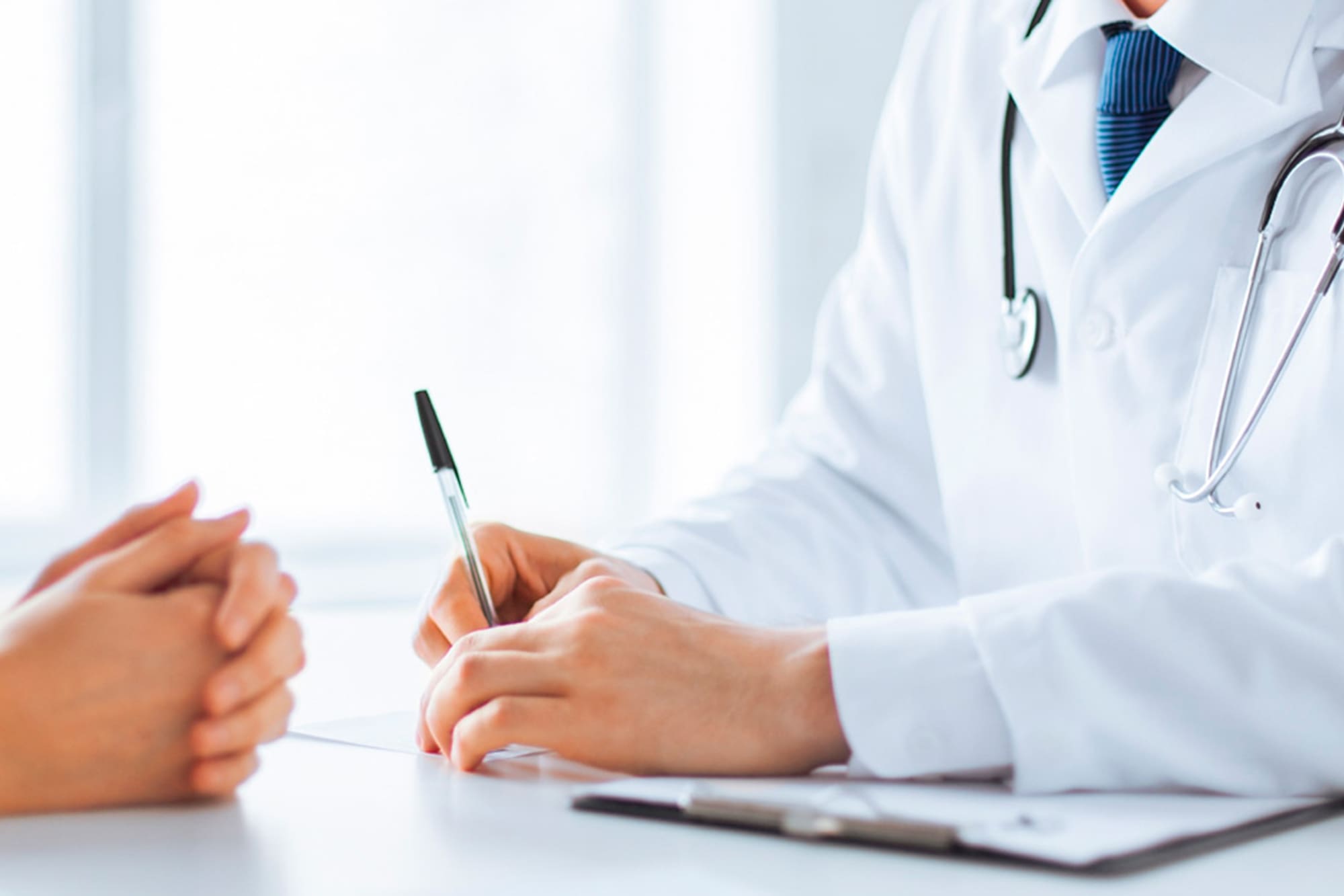 a doctor writing on a paper