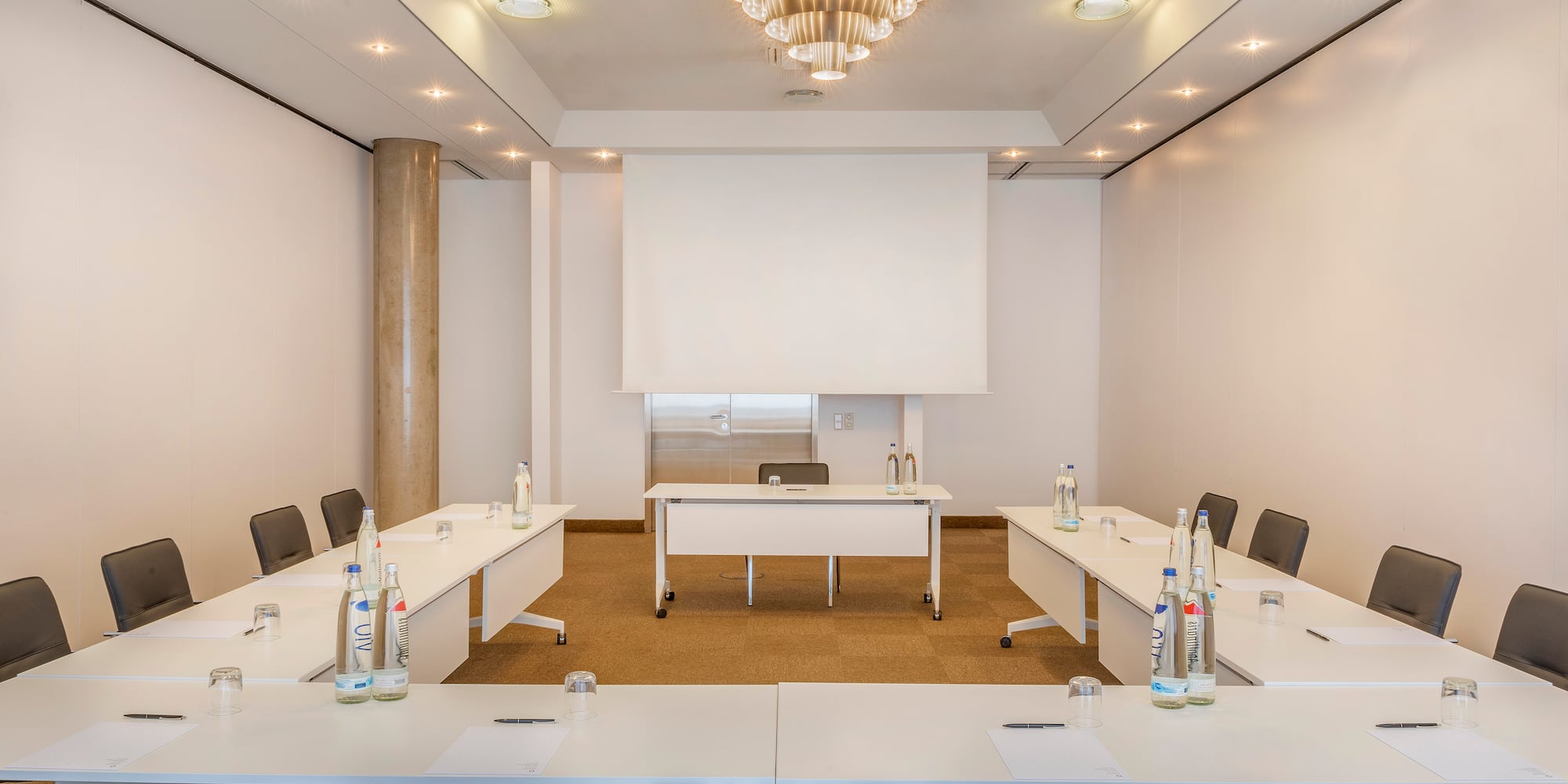 a room with white tables and chairs