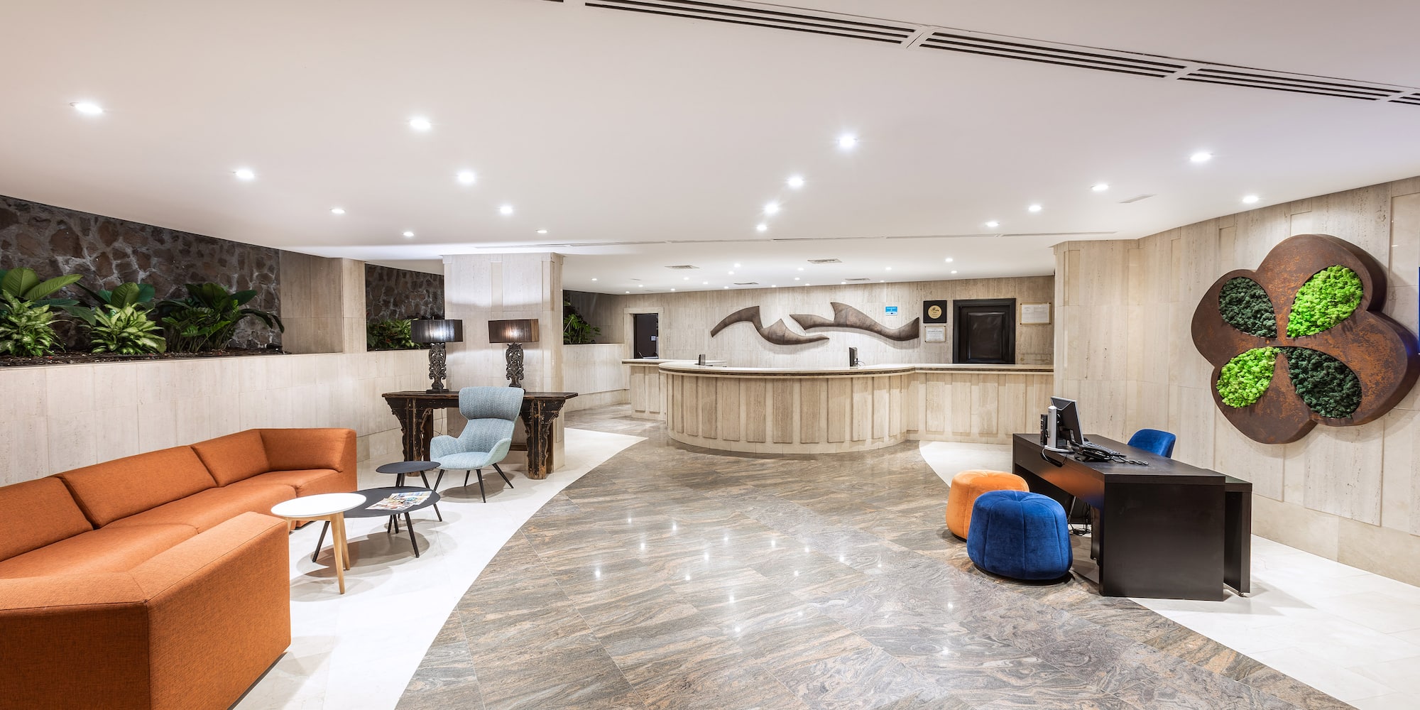 a lobby with a reception desk and chairs