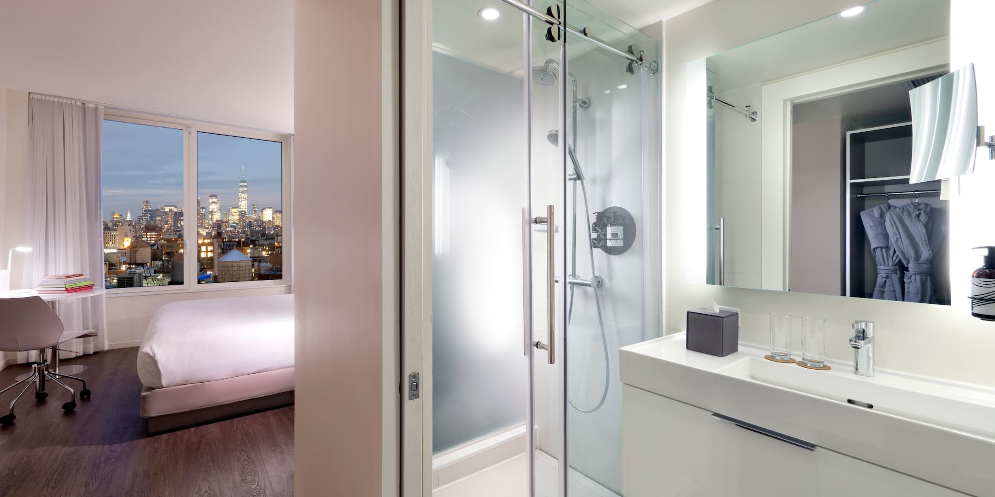a bathroom with a glass shower and a bed