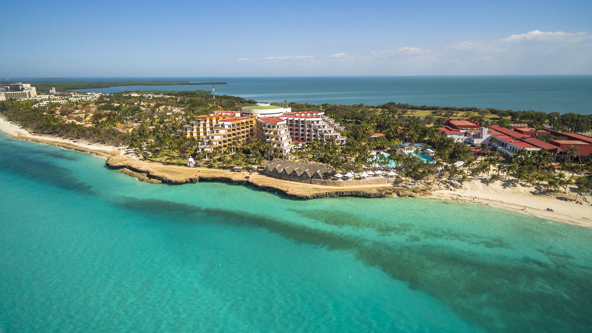 a beach with buildings and trees