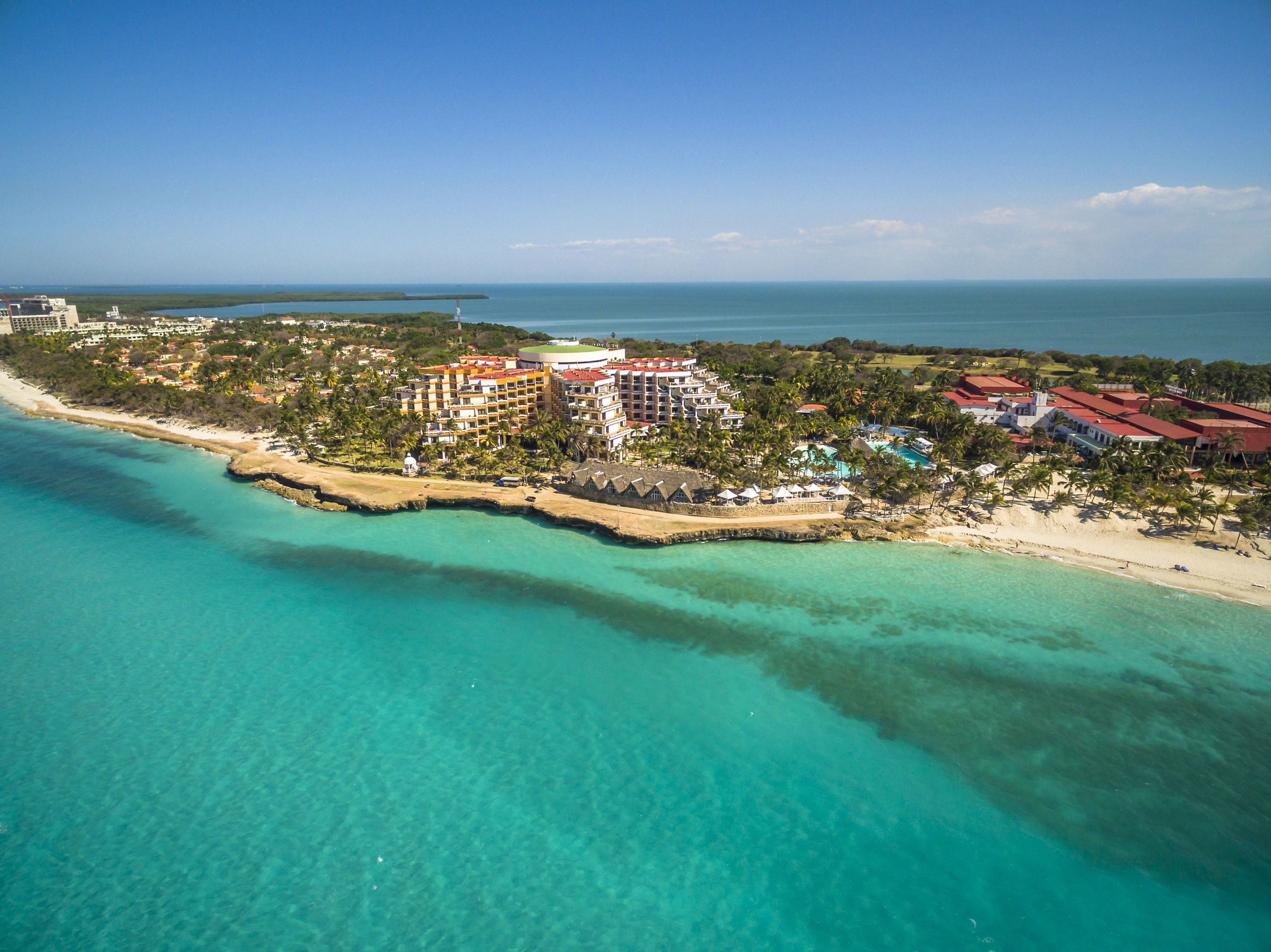 a beach with buildings and trees