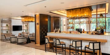 a bar with chairs and a tv