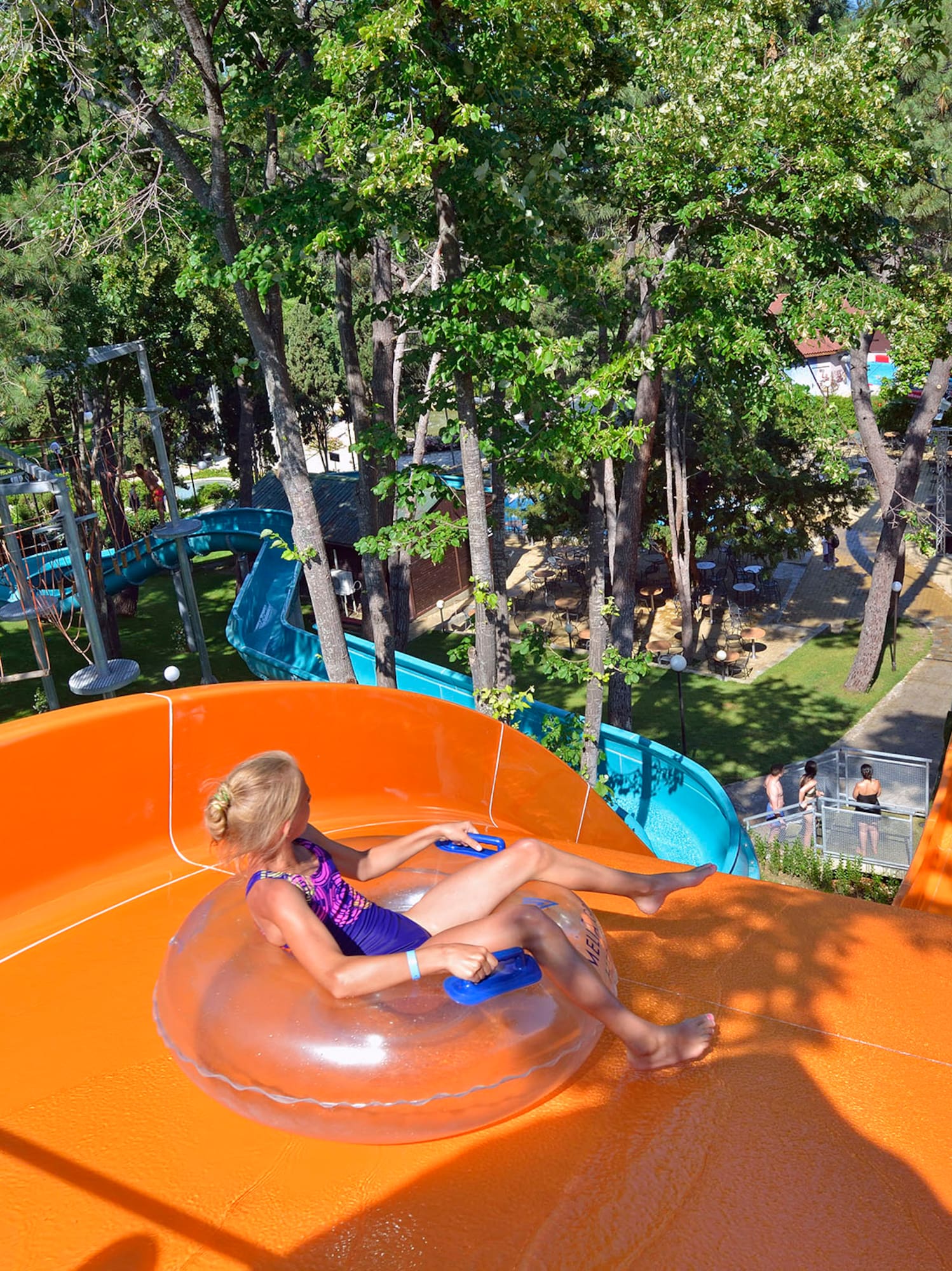 a girl in a swimsuit on an orange water slide