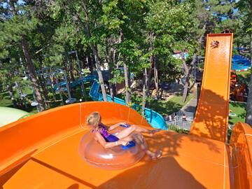 a girl in a swimsuit on an orange water slide