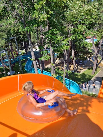 a girl in a swimsuit on an orange water slide