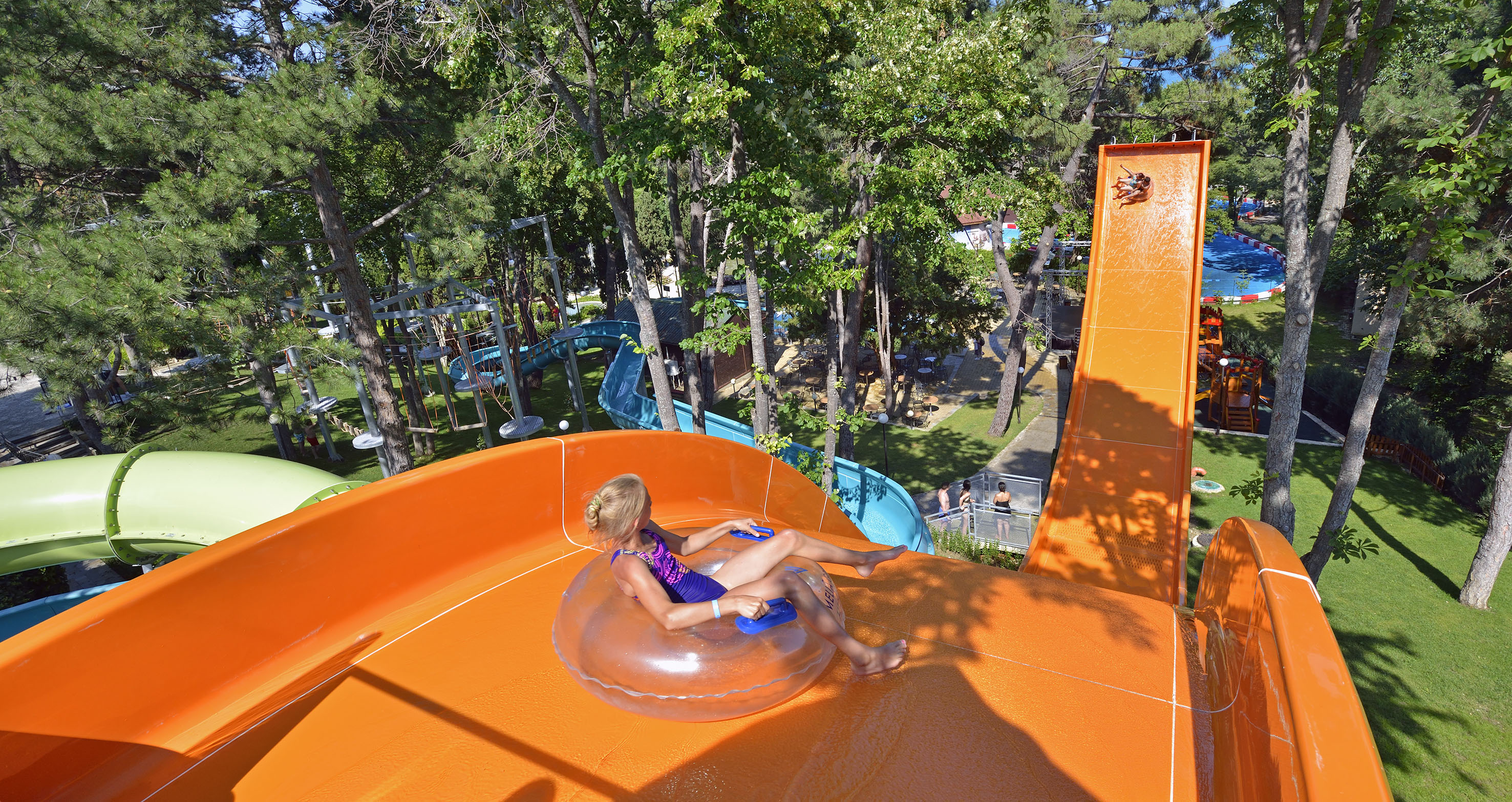 a girl in a swimsuit on an orange water slide