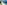 Aerial view: Tropical white sand beach with turquoise ocean and palm trees.