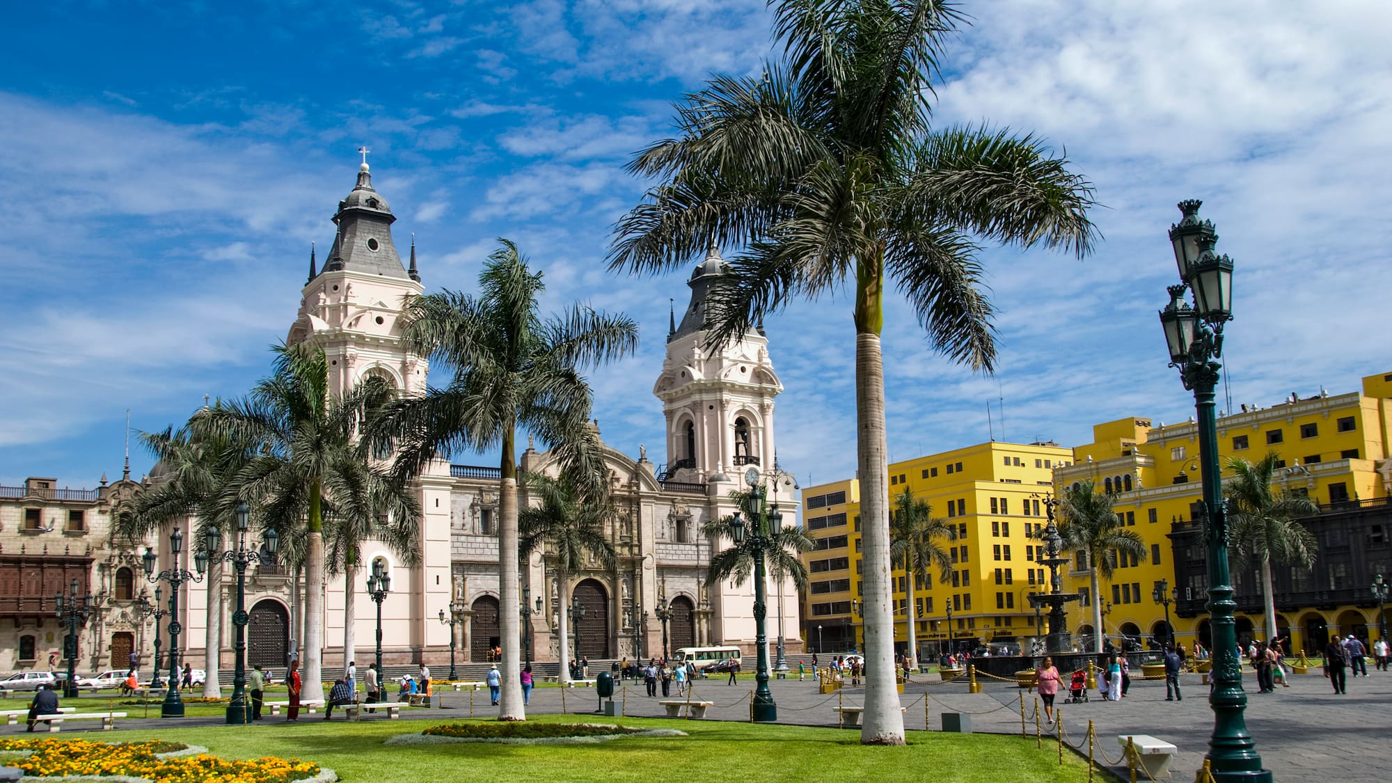 a large building with palm trees in front of it