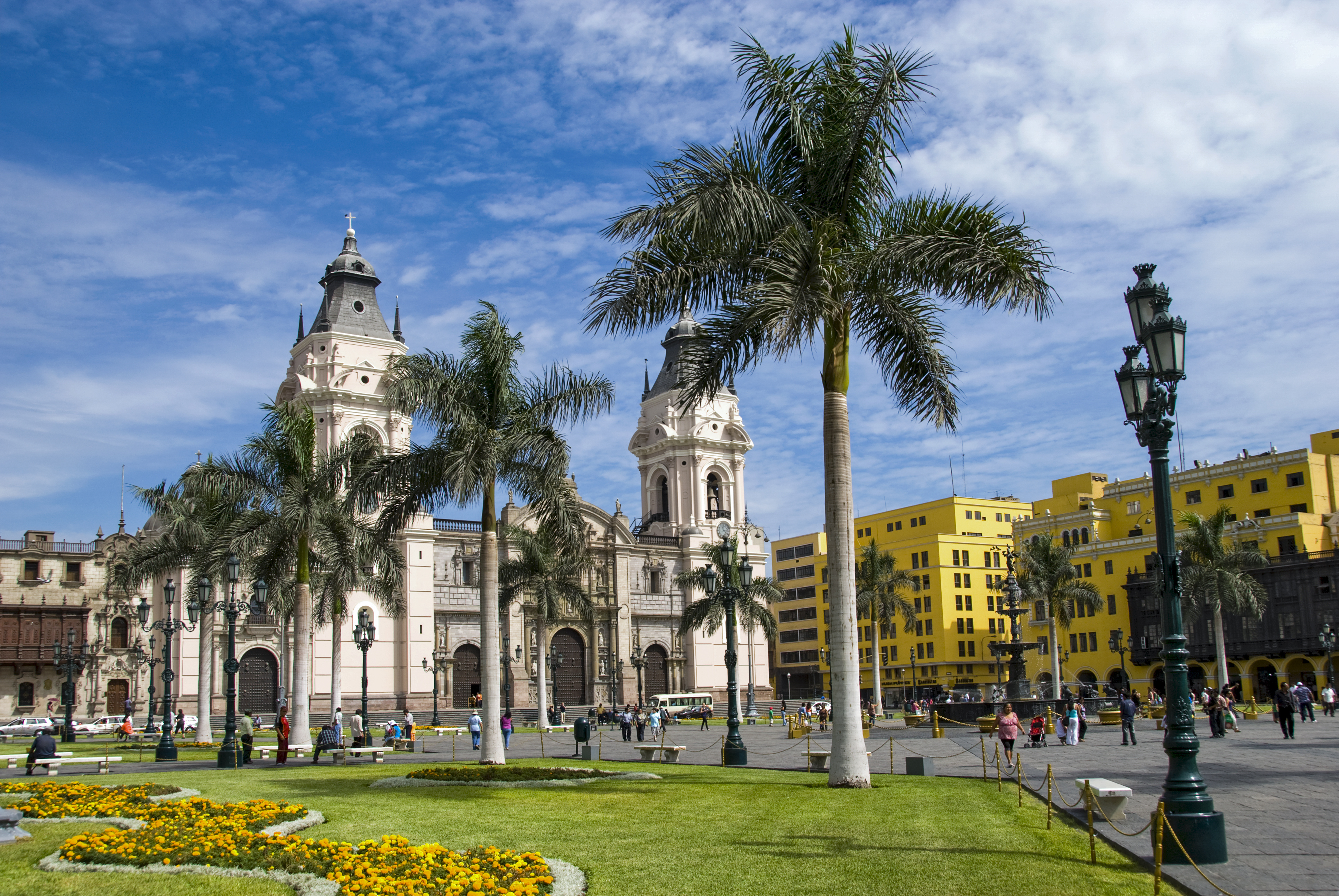 a large building with palm trees in front of it