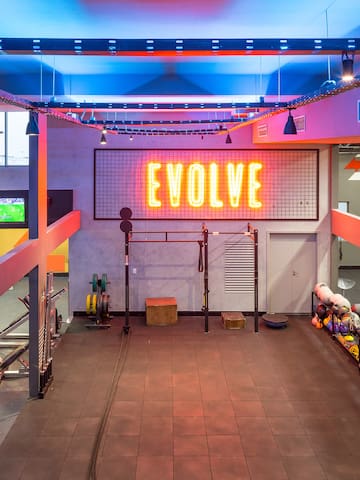 a gym with a neon sign