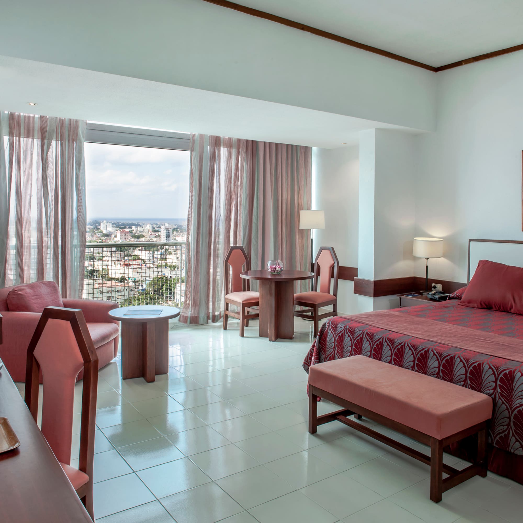 a room with a bed and chairs and a table