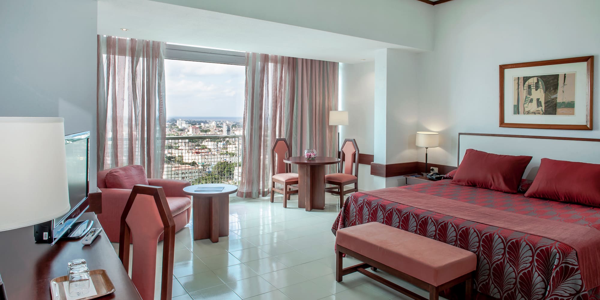 a room with a bed and chairs and a table