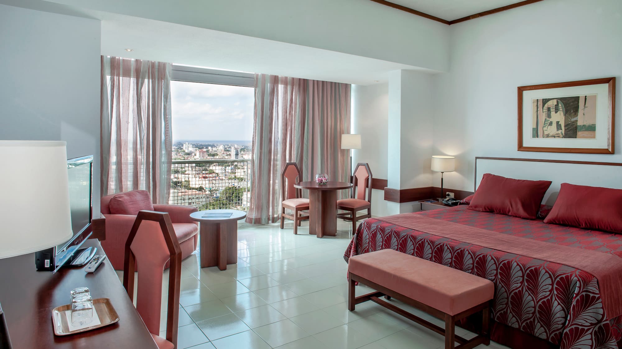 a room with a bed and chairs and a table