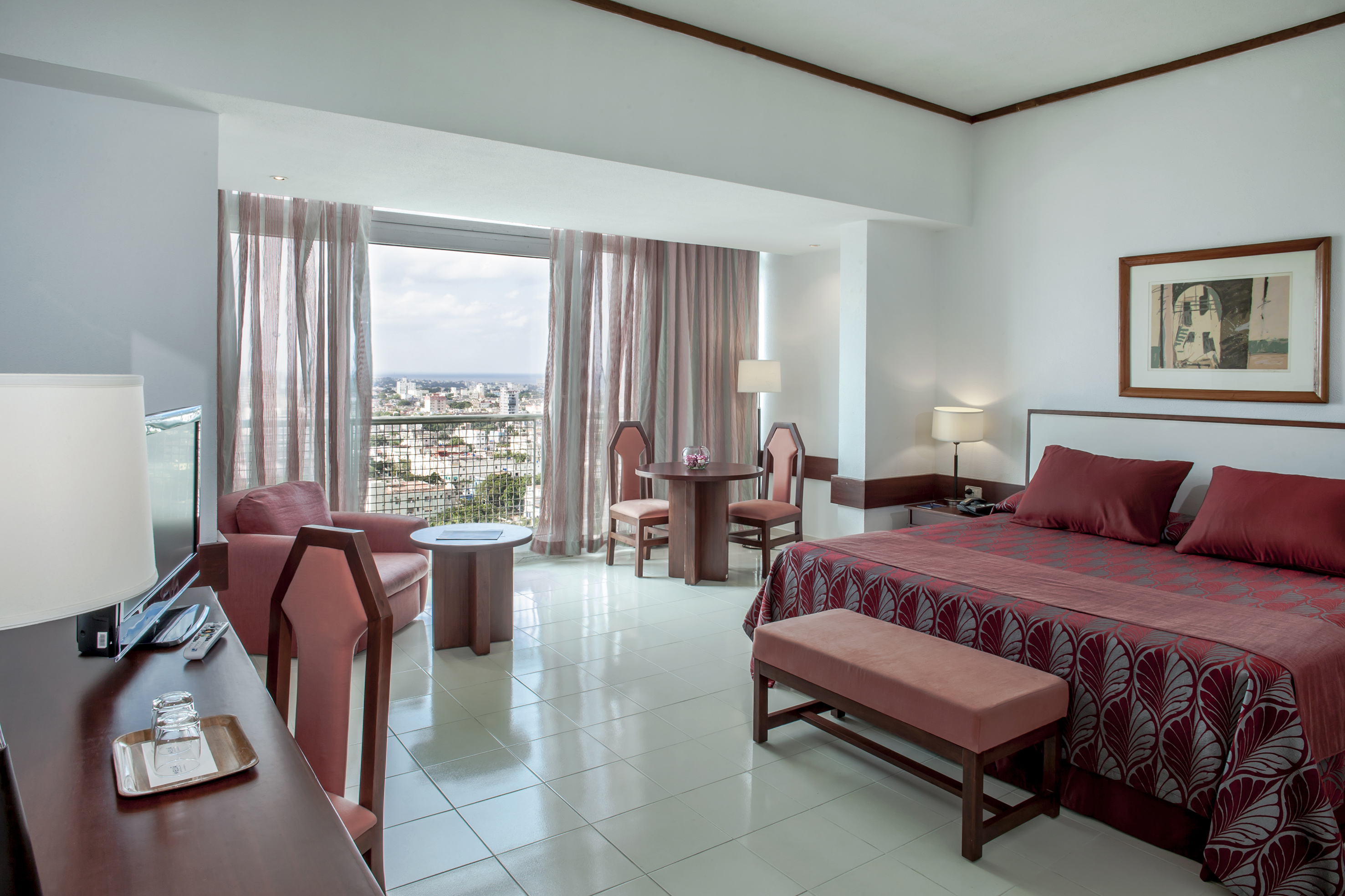 a room with a bed and chairs and a table