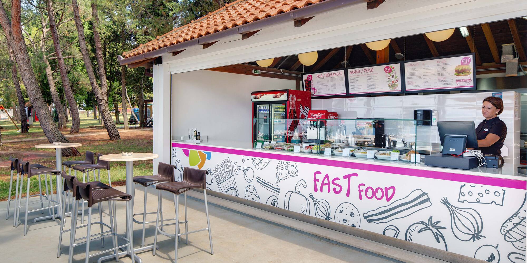 a fast food stand outside with tables and chairs