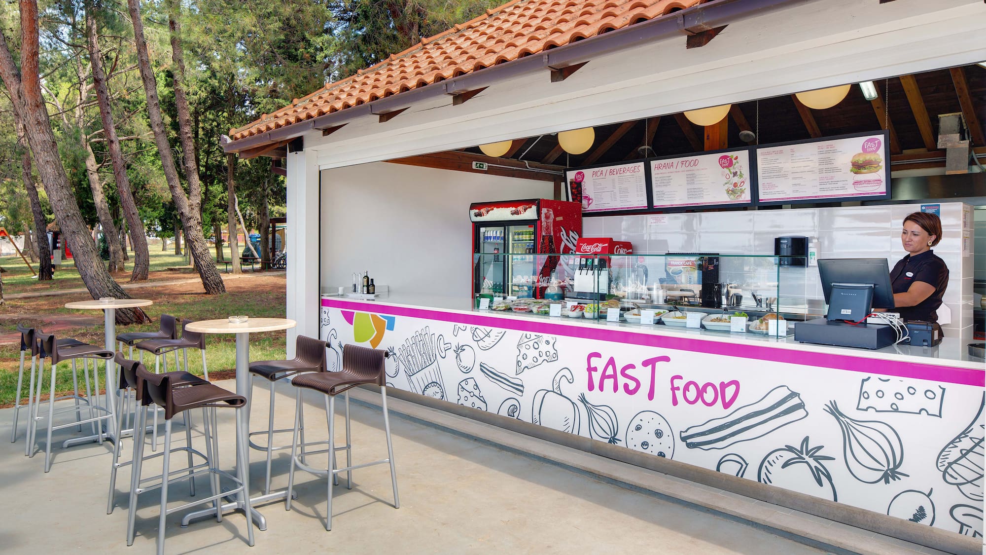 a fast food stand outside with tables and chairs