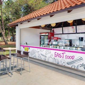a fast food stand outside with tables and chairs