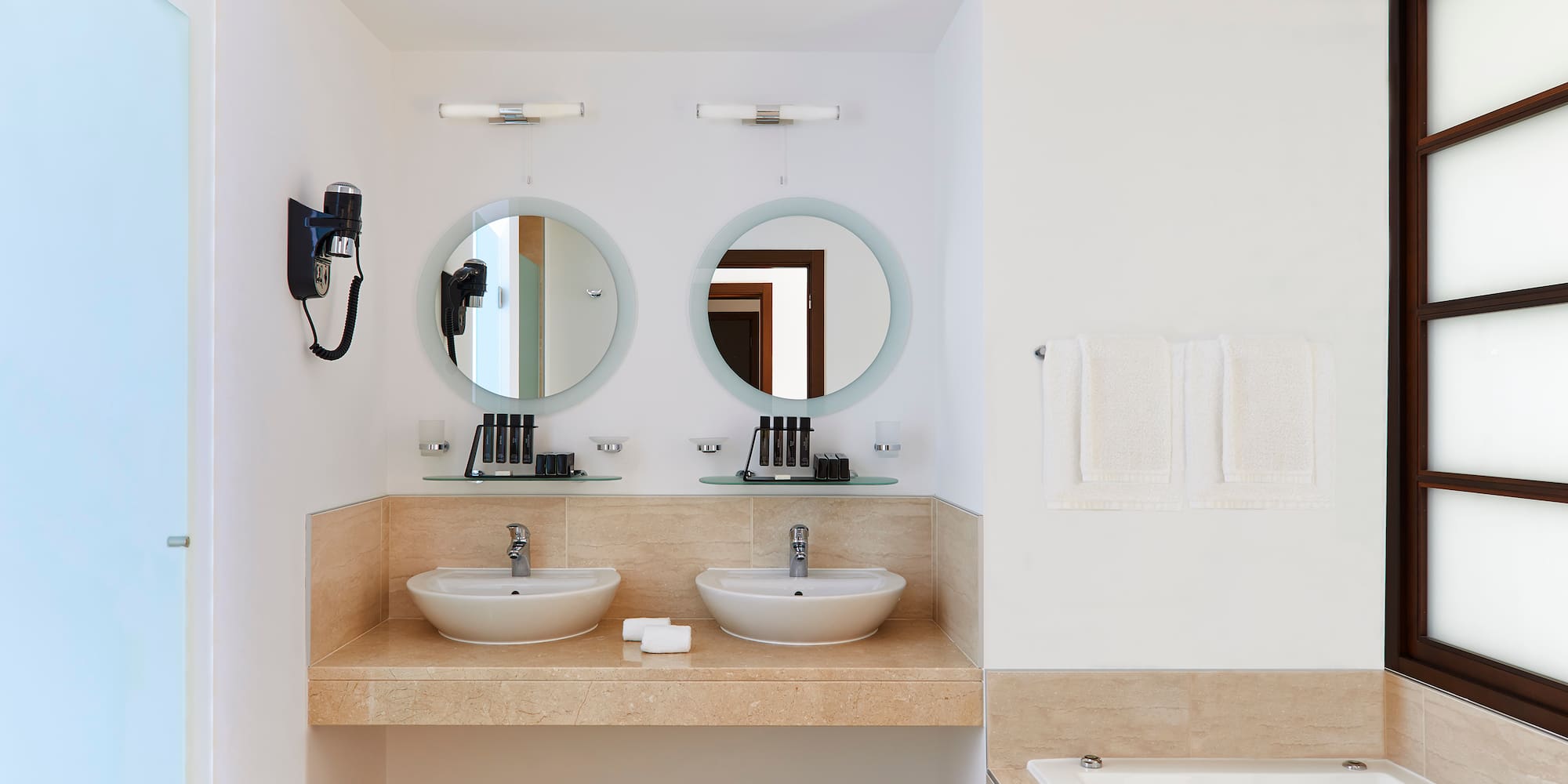 a bathroom with two sinks and a bathtub
