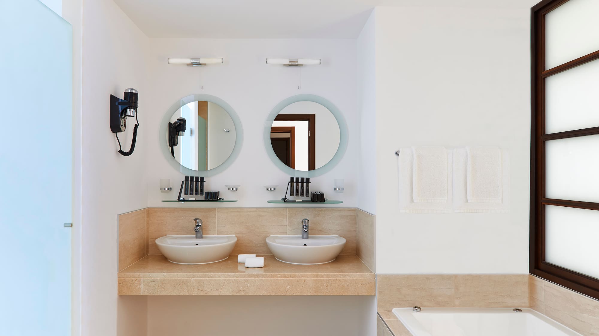 a bathroom with two sinks and a bathtub