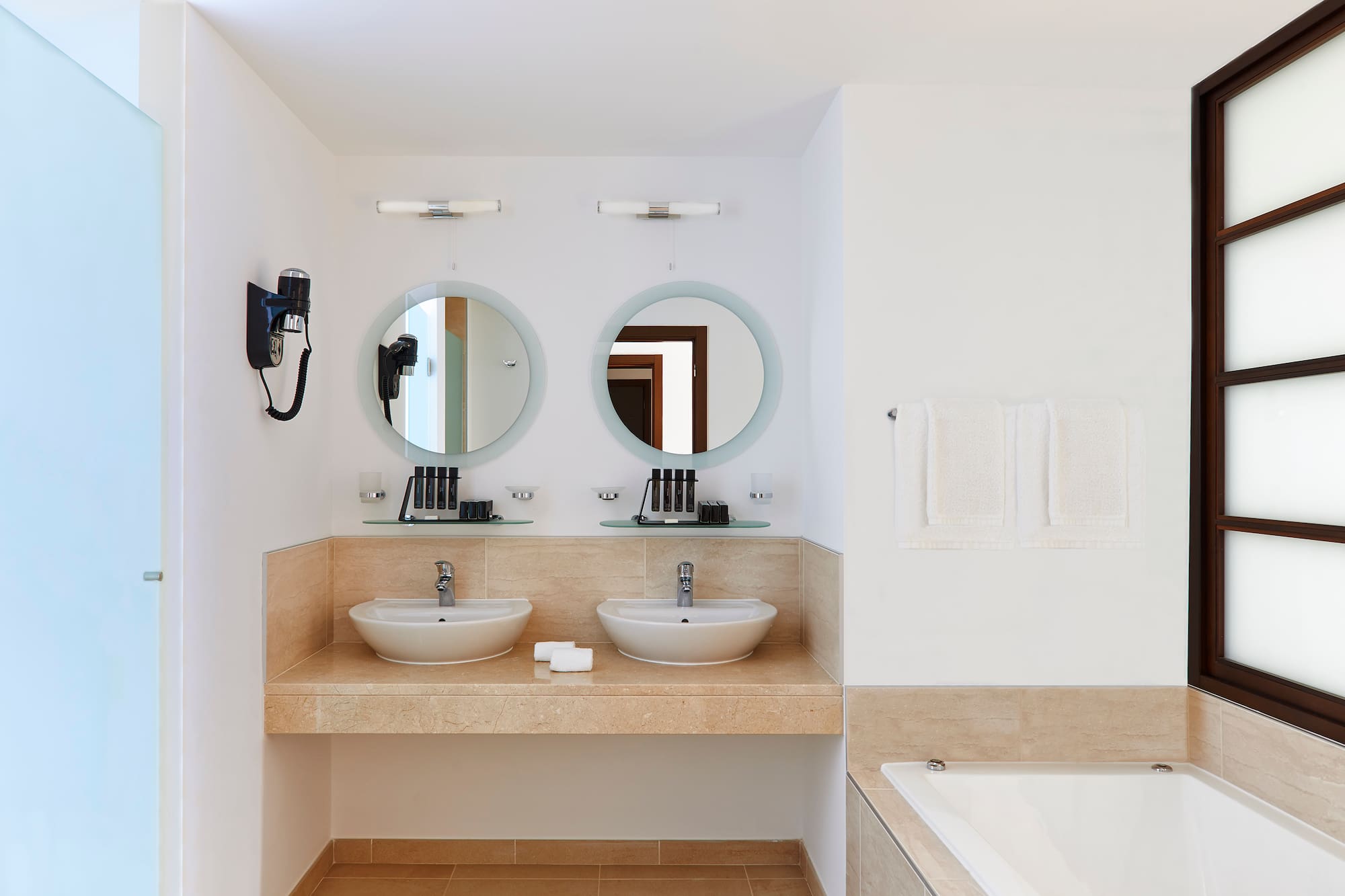 a bathroom with two sinks and a bathtub