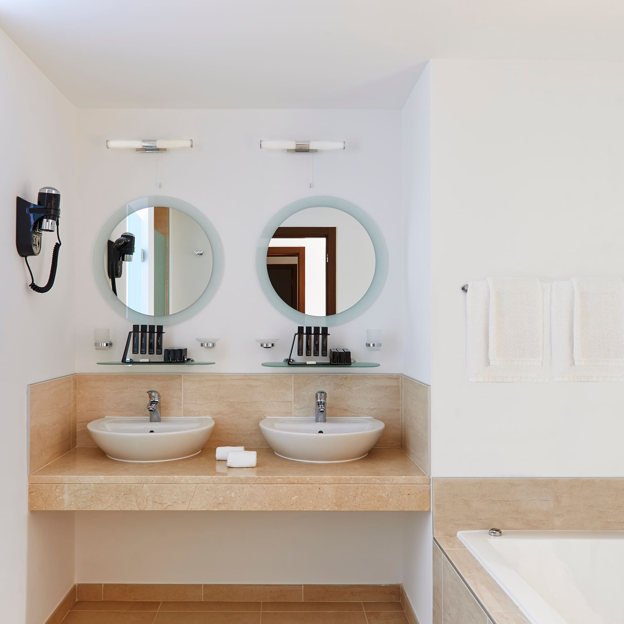 a bathroom with two sinks and a bathtub