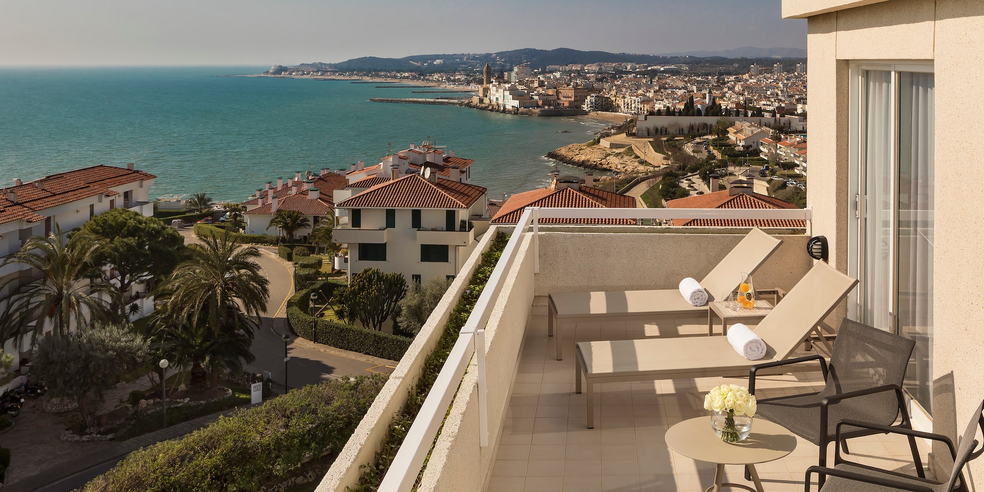 a deck with chairs and a view of the ocean