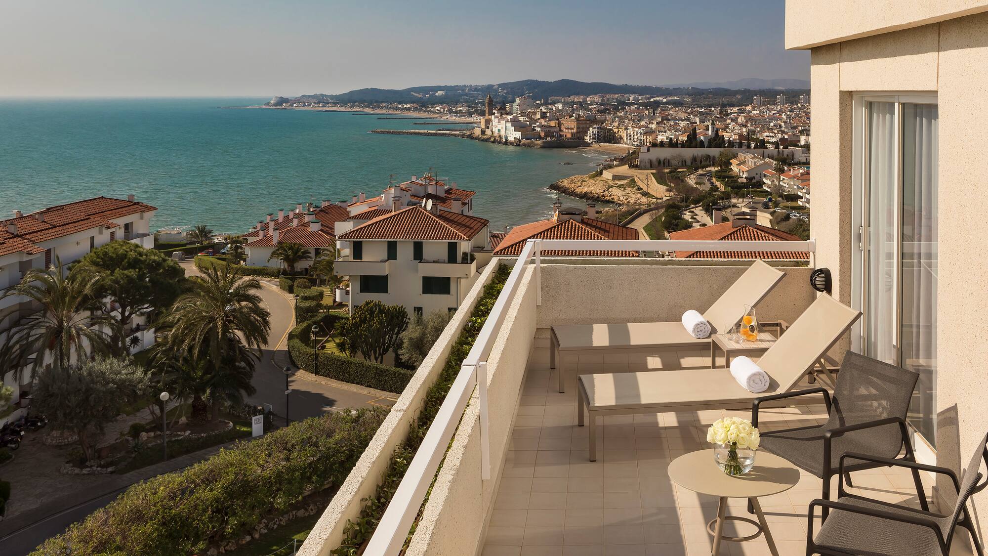 a deck with chairs and a view of the ocean